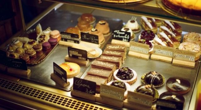 Assorted French pastries at a Paris patisserie counter with price tags