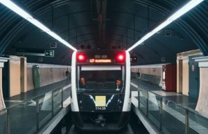 Barcelona Metro & TMB Guide: Tickets, Passes & Airport (First-Timer Tips) Front of Barcelona FGC metro train on Line L7 to Plaça Catalunya inside a modern station