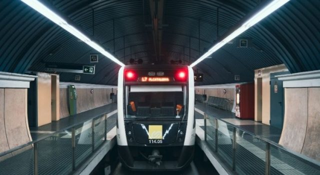 Front of Barcelona FGC metro train on Line L7 to Plaça Catalunya inside a modern station