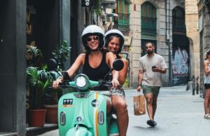 Barcelona in Summer: What to Wear (Packing List + Outfit Ideas) Summer outfits on a scooter in a narrow Barcelona street