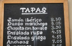 Barcelona Tapas Guide: 21 Must-Try Bites + How to Order Chalkboard tapas menu outside a bar in Barcelona