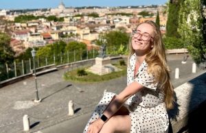 Hidden Rome: 20 Quiet Corners Beyond the Crowds Traveler relaxing on a quiet terrace on Rome’s Aventine Hill with city view