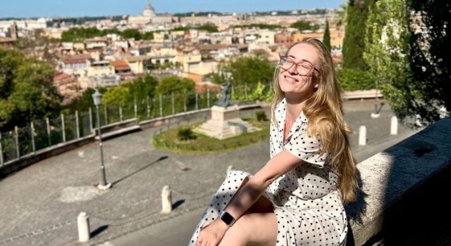 Traveler relaxing on a quiet terrace on Rome’s Aventine Hill with city view