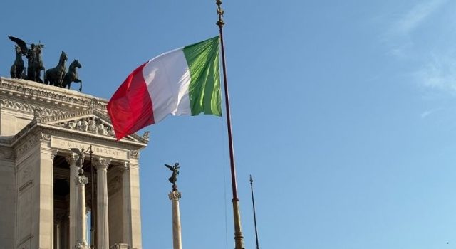 Italian flag flying in central Rome, symbolizing safety and public life near metro areas