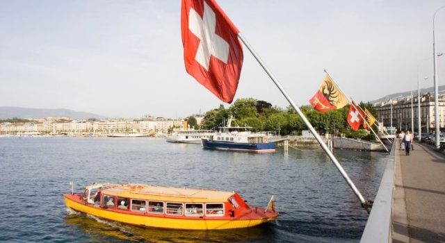 Public transport boat on Lake Geneva near the city center, showing how visitors can travel for free with the Geneva Transport Card.